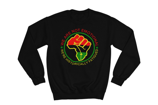 Black  crewneck sweatshirt featuring a circular design with a raised fist symbol in Pan-African colors (red, black, green). The fist is surrounded by a green circle, and the text 'WE ARE NOT EMOTIONAL WE'RE HISTORICALLY FATIGUED' is written around it in red, yellow, and green.