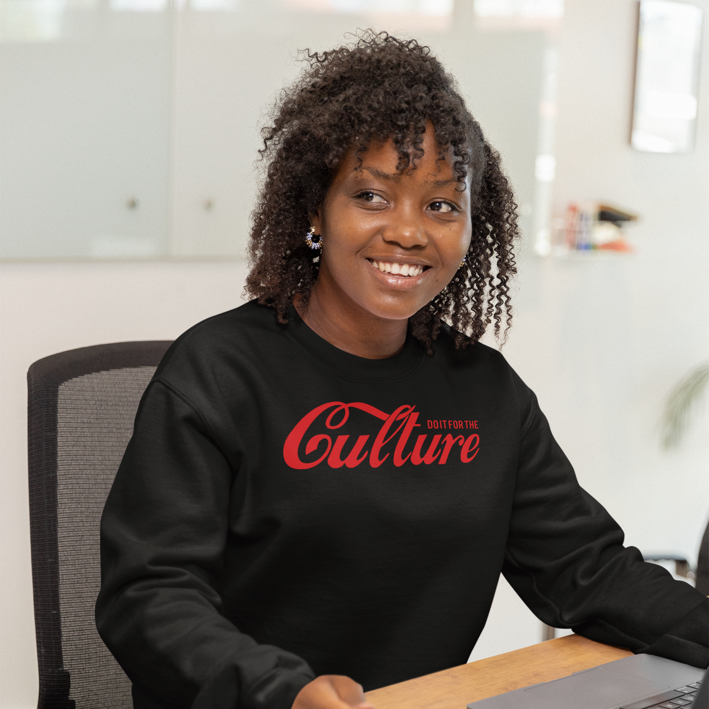 Woman wearing a black Do It for the Culture iconic crewneck sweatshirt